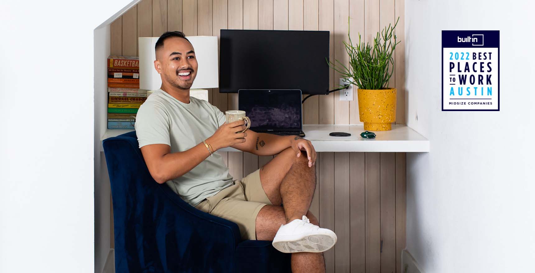 Professional man sits and smiles in home office