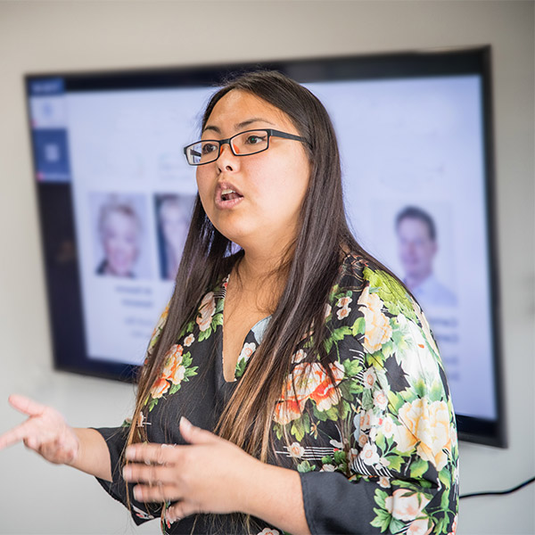 Woman presents in front of monitor