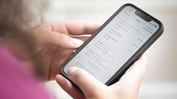 Care Professional checks schedule on mobile phone