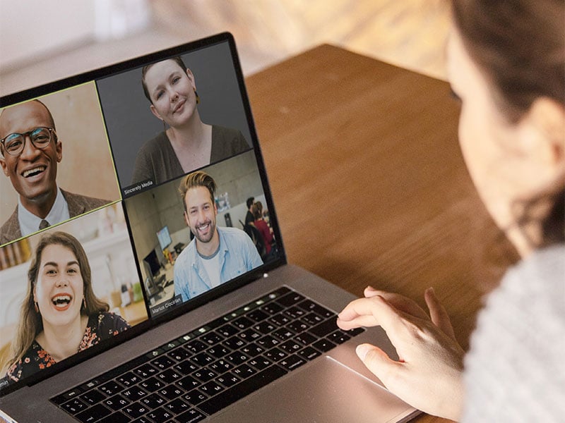 Young woman on zoom call with other professionals